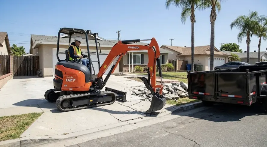 Kubota U27 mini excavator removing concrete driveway in Orange County CA